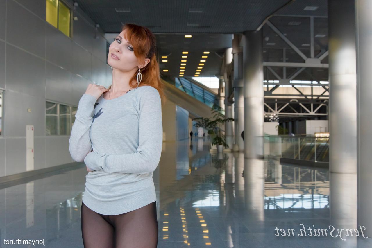 15P Redheaded babe Jeny Smith showing her sexy legs in sheer black pantyhose