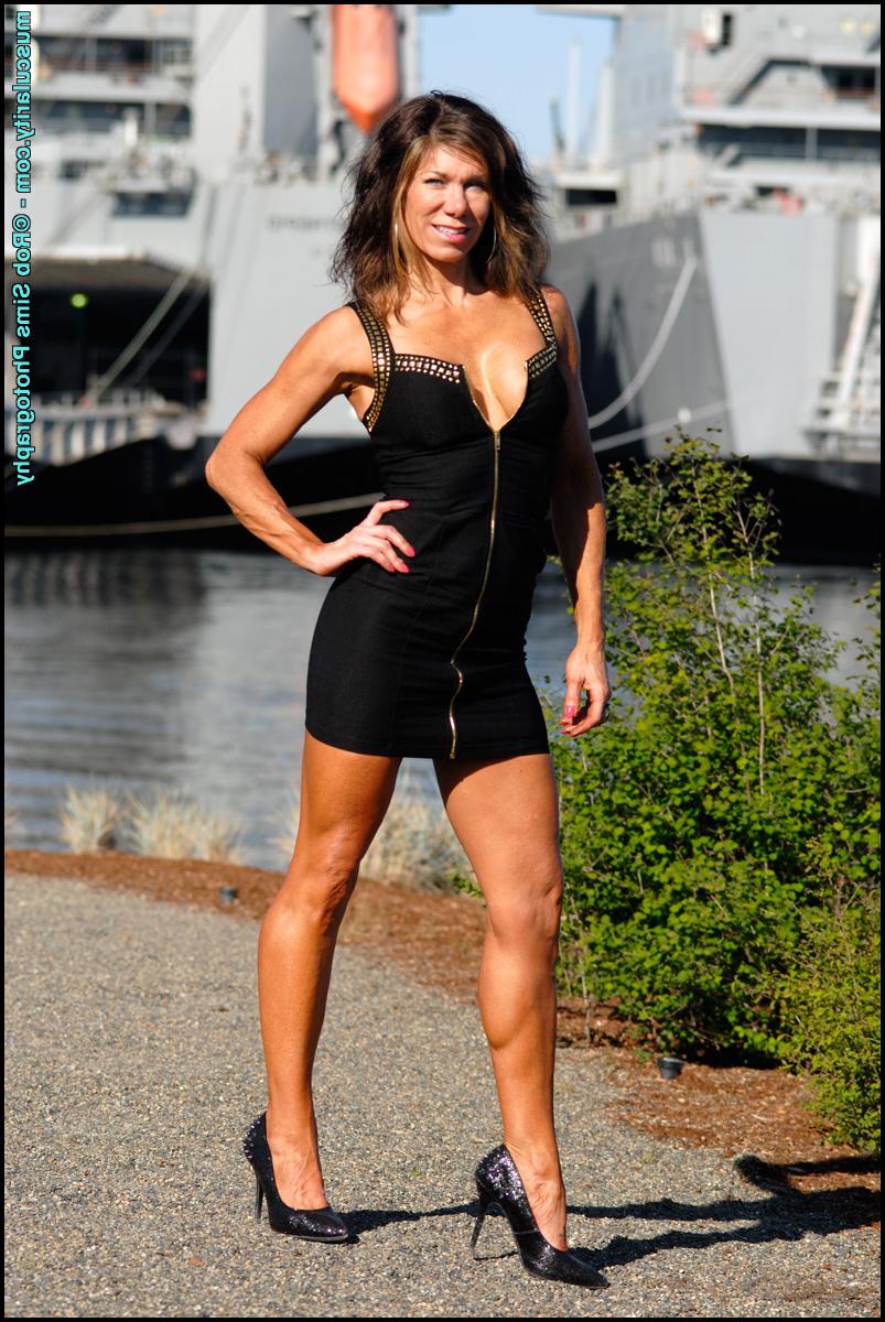 15P Bodybuilder Tammy Marie slips the straps of her dress over her bare shoulders