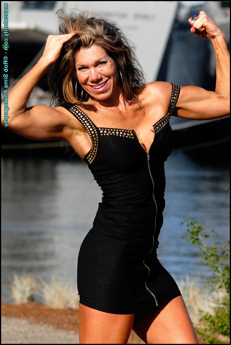 15P Bodybuilder Tammy Marie slips the straps of her dress over her bare shoulders