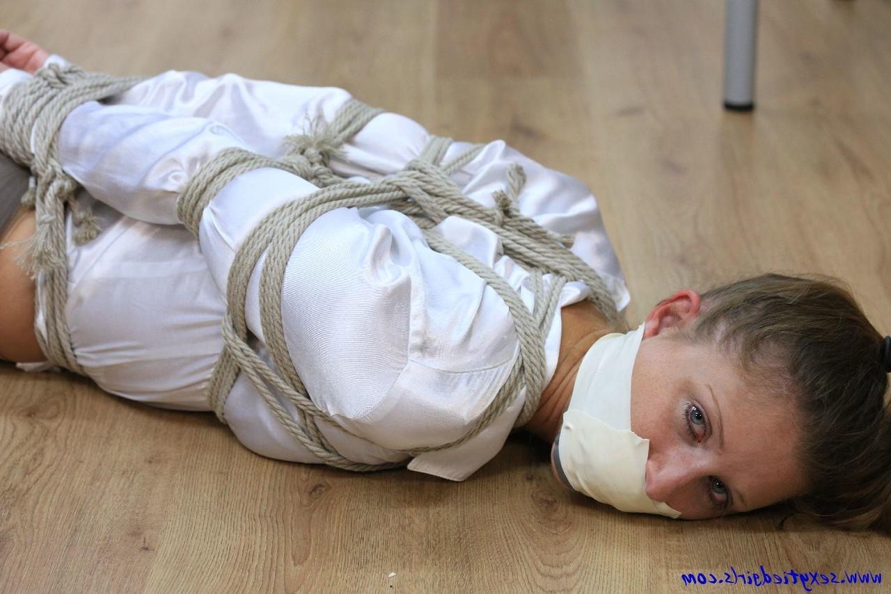 16P Clothed woman is tied up with ropes while silenced with tape over her mouth