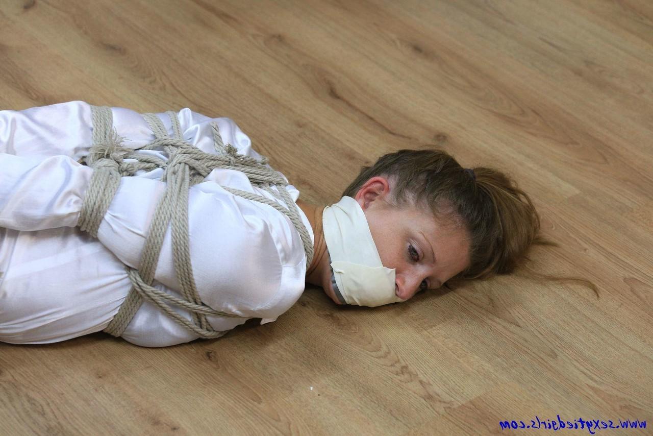 16P Clothed woman is tied up with ropes while silenced with tape over her mouth