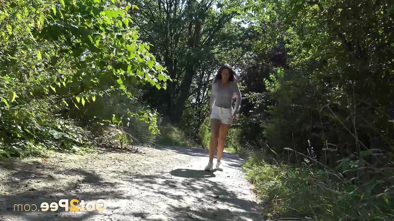 15P Caucasian girl Esperansa gets caught taking a piss on a path in the woods