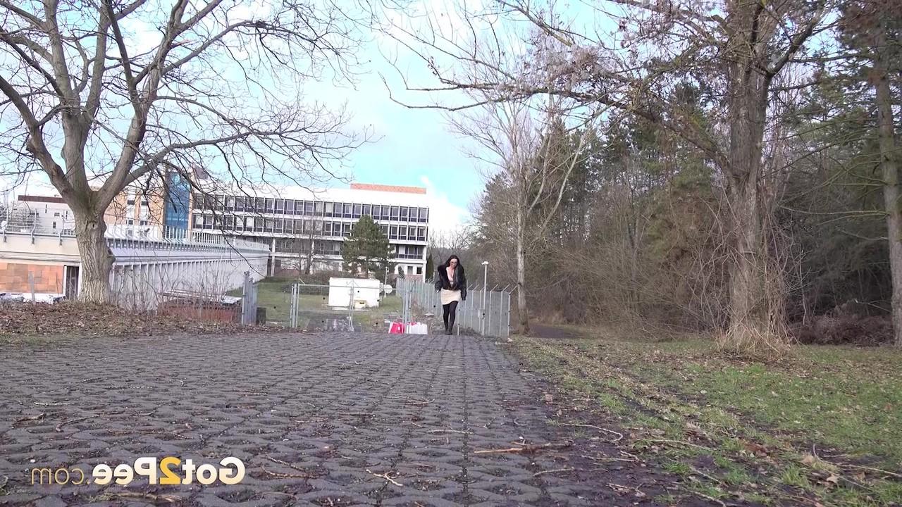 15P Shalina Shine holds her ass while taking a piss on a public walkway