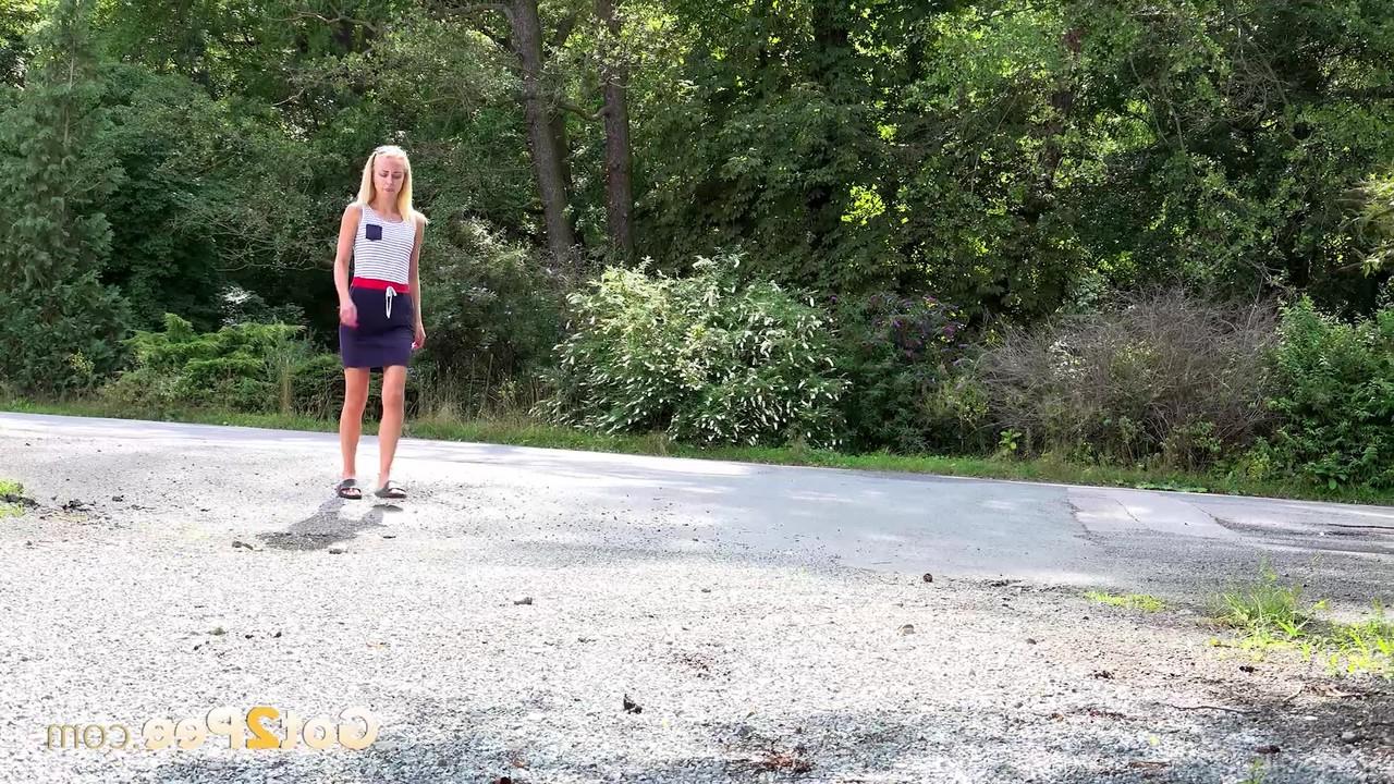 15P La petite blonde Debora s'accroupit pour pisser sur le bord d'une route pendant que les voitures passent.