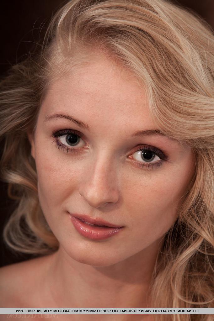 18P Tiny titted Leona Honey takes of blouse to show naked body in sensual poses