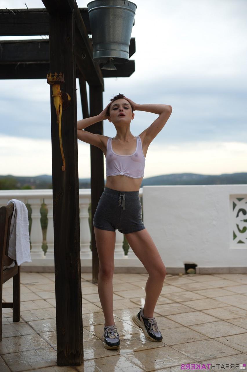 12P Solo model Caterina Foxy smokes after getting soaked under an outdoor shower
