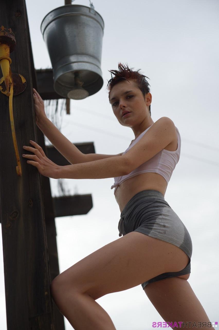 12P Solo model Caterina Foxy smokes after getting soaked under an outdoor shower