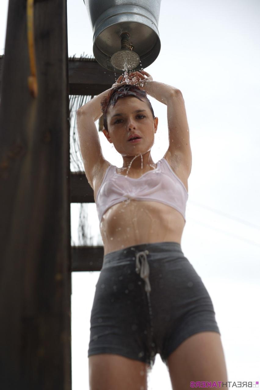 12P Solo model Caterina Foxy smokes after getting soaked under an outdoor shower