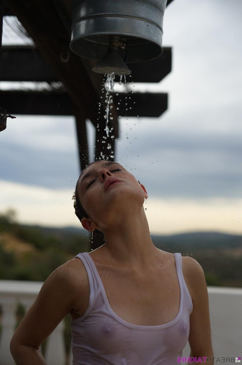 12P Solo model Caterina Foxy smokes after getting soaked under an outdoor shower