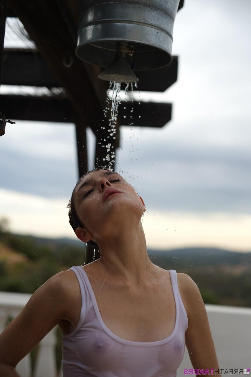 12P Solo model Caterina Foxy smokes after getting soaked under an outdoor shower