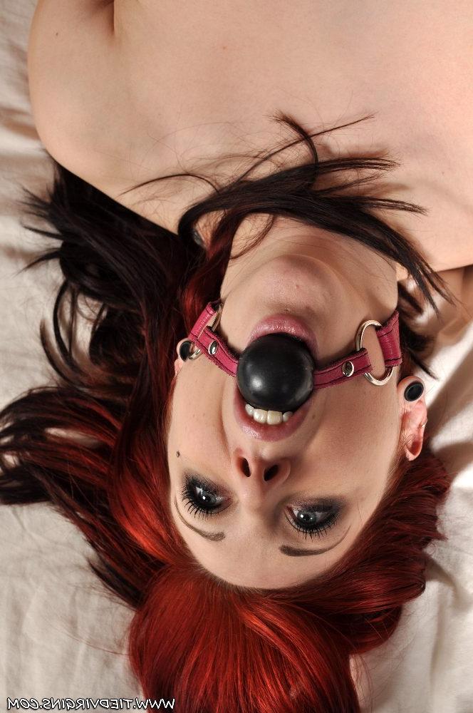 12P Topless redhead Shay Hendrix struggles against a ball gag while tied to a bed