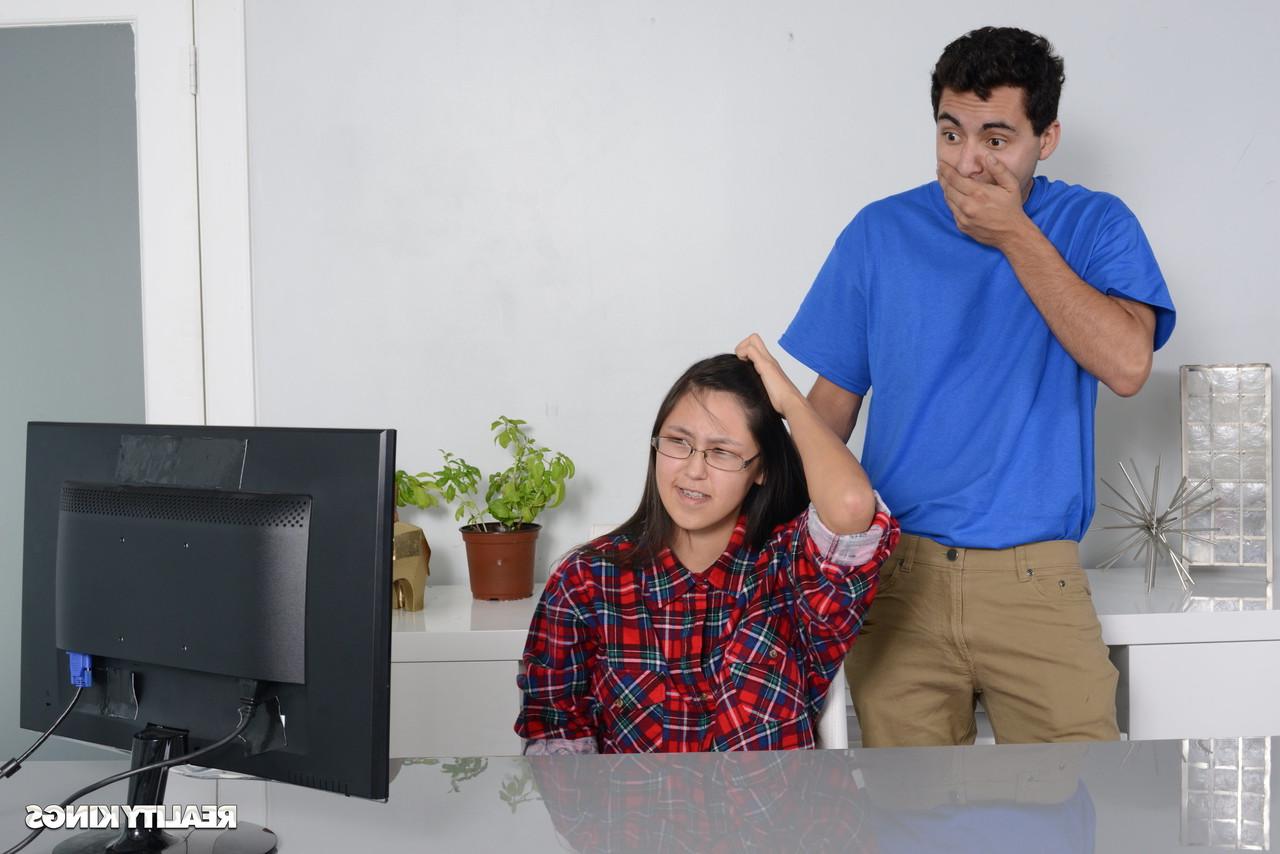 16P Petite Asian babe gets caught by her stepbrother watching porn on the PC