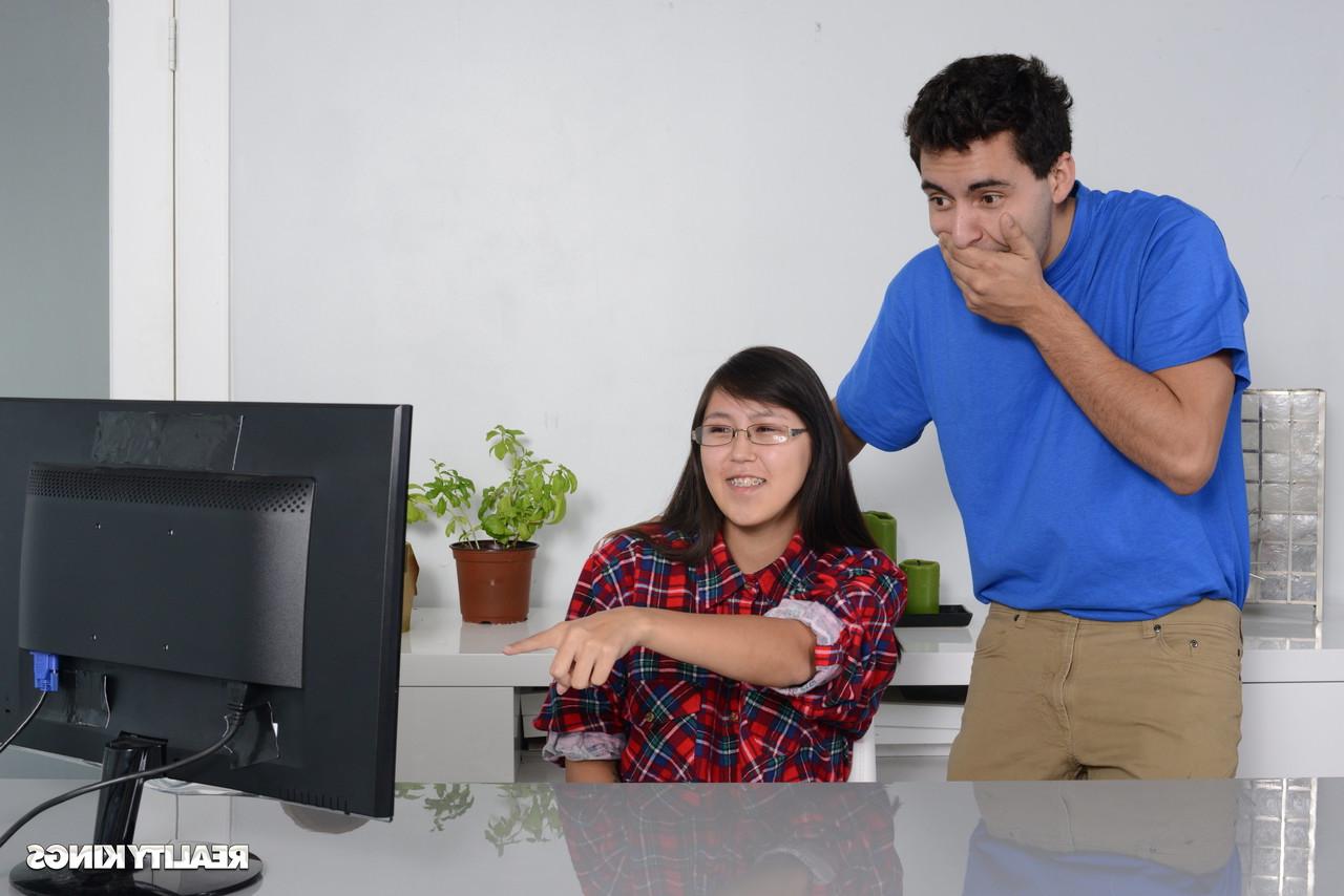16P Petite Asian babe gets caught by her stepbrother watching porn on the PC