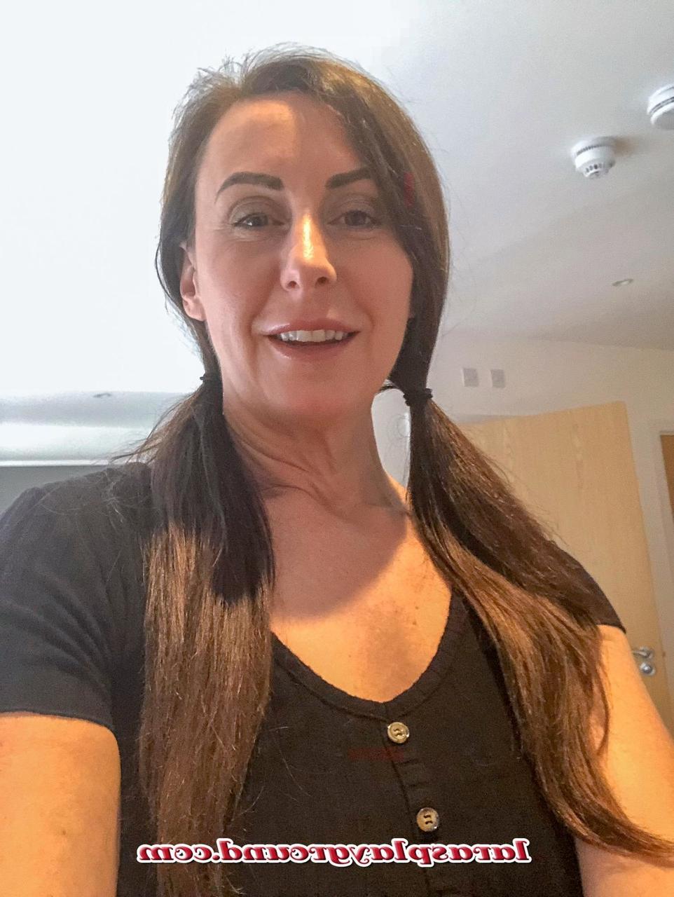15P MILF Lara shows her big ass while posing in a schoolgirl outfit & stockings