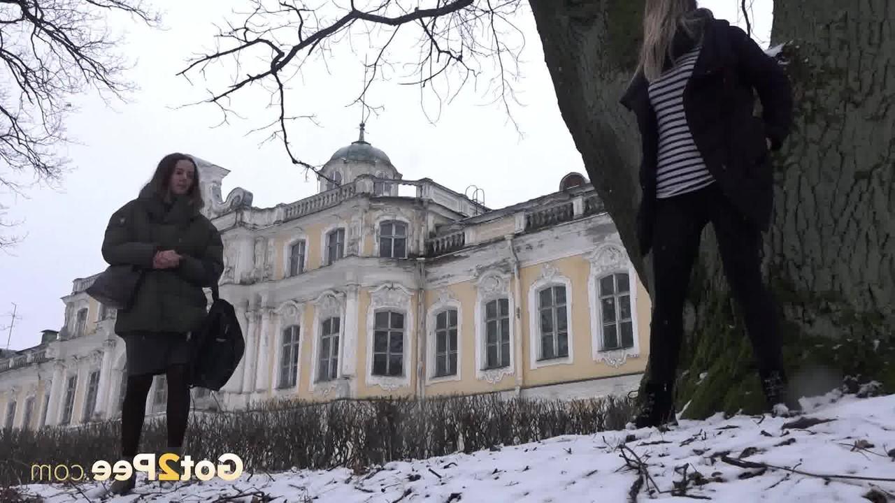 12P Das blonde Mädchen Masha pinkelt auf schneebedecktem Boden gegen einen alten Baum