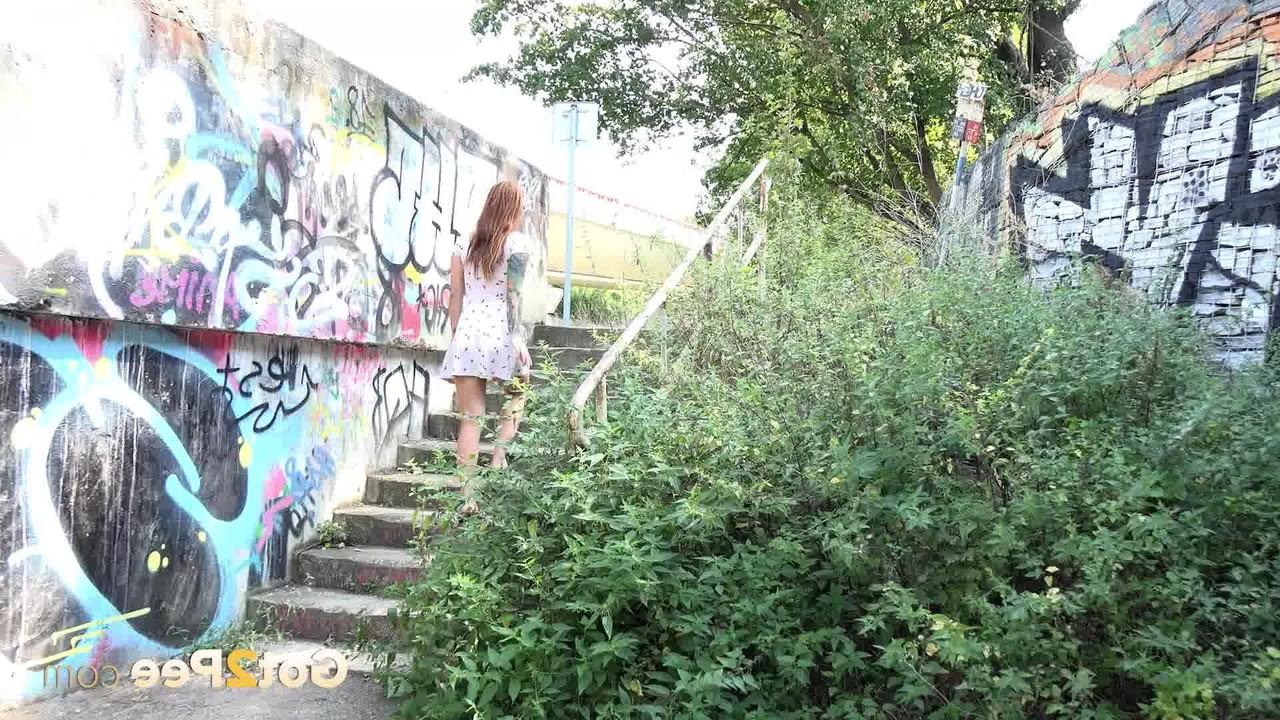 15P Tattooed redhead Foxie T takes a piss in a graffitied underpass
