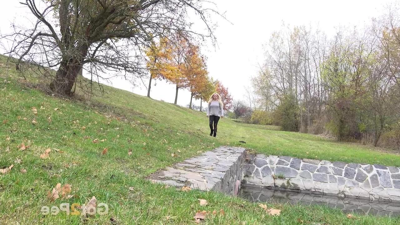 15P Chubby blonde Henriet gets caught taking a pee in an outdoor location