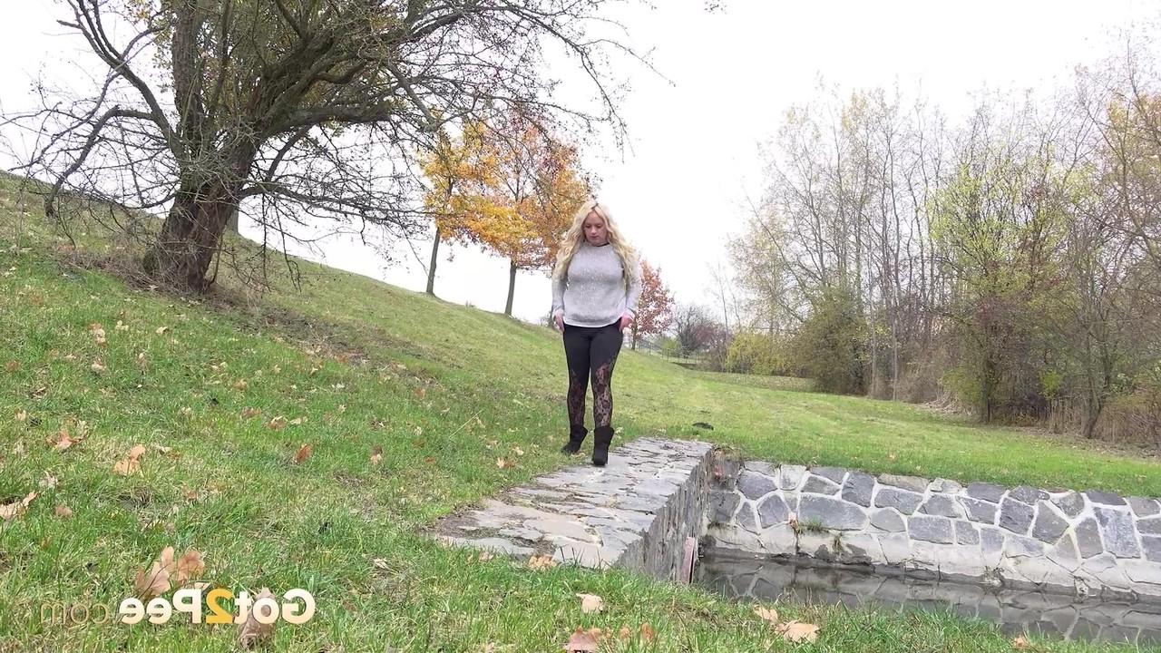 15P Chubby blonde Henriet gets caught taking a pee in an outdoor location