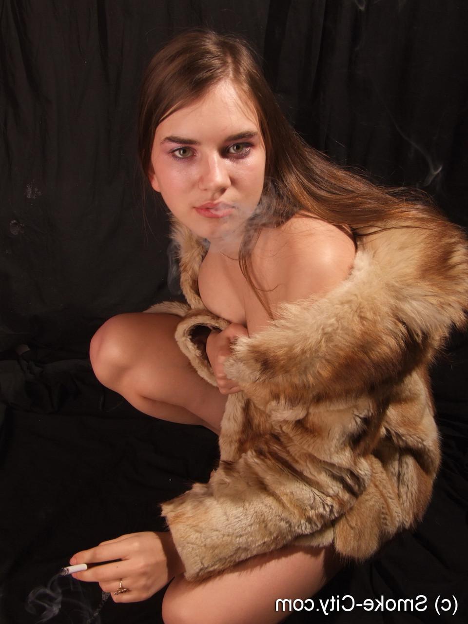 16P Amateur model smokes while removing fur coat for nude poses