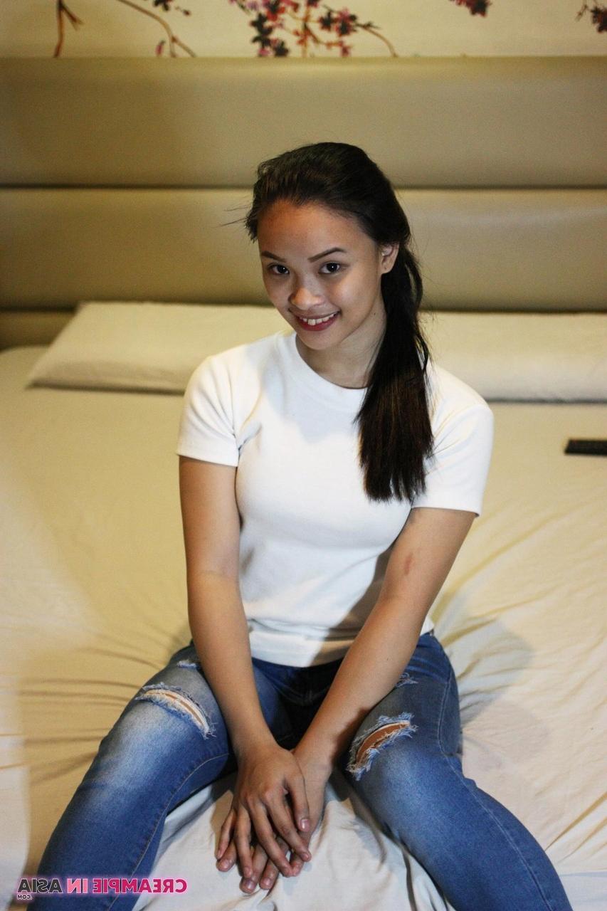 14P Beautiful Asian girl Miles posing in her shirt & tight jeans in a hotel room