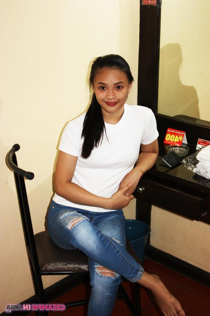 14P Beautiful Asian girl Miles posing in her shirt & tight jeans in a hotel room