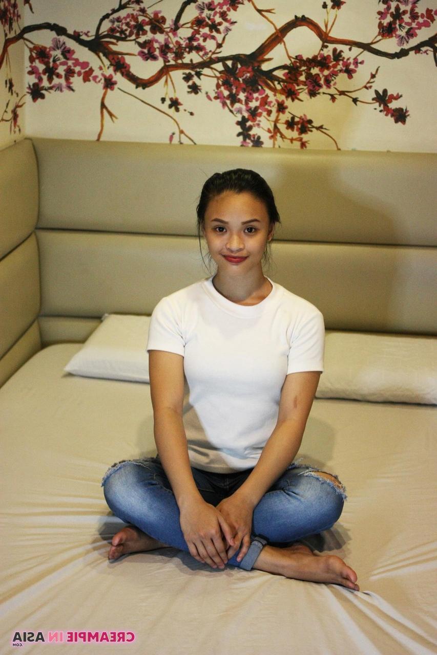 14P Beautiful Asian girl Miles posing in her shirt & tight jeans in a hotel room