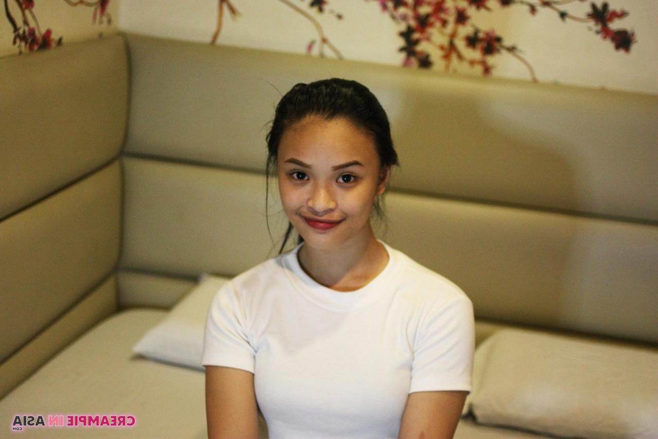 14P Beautiful Asian girl Miles posing in her shirt & tight jeans in a hotel room