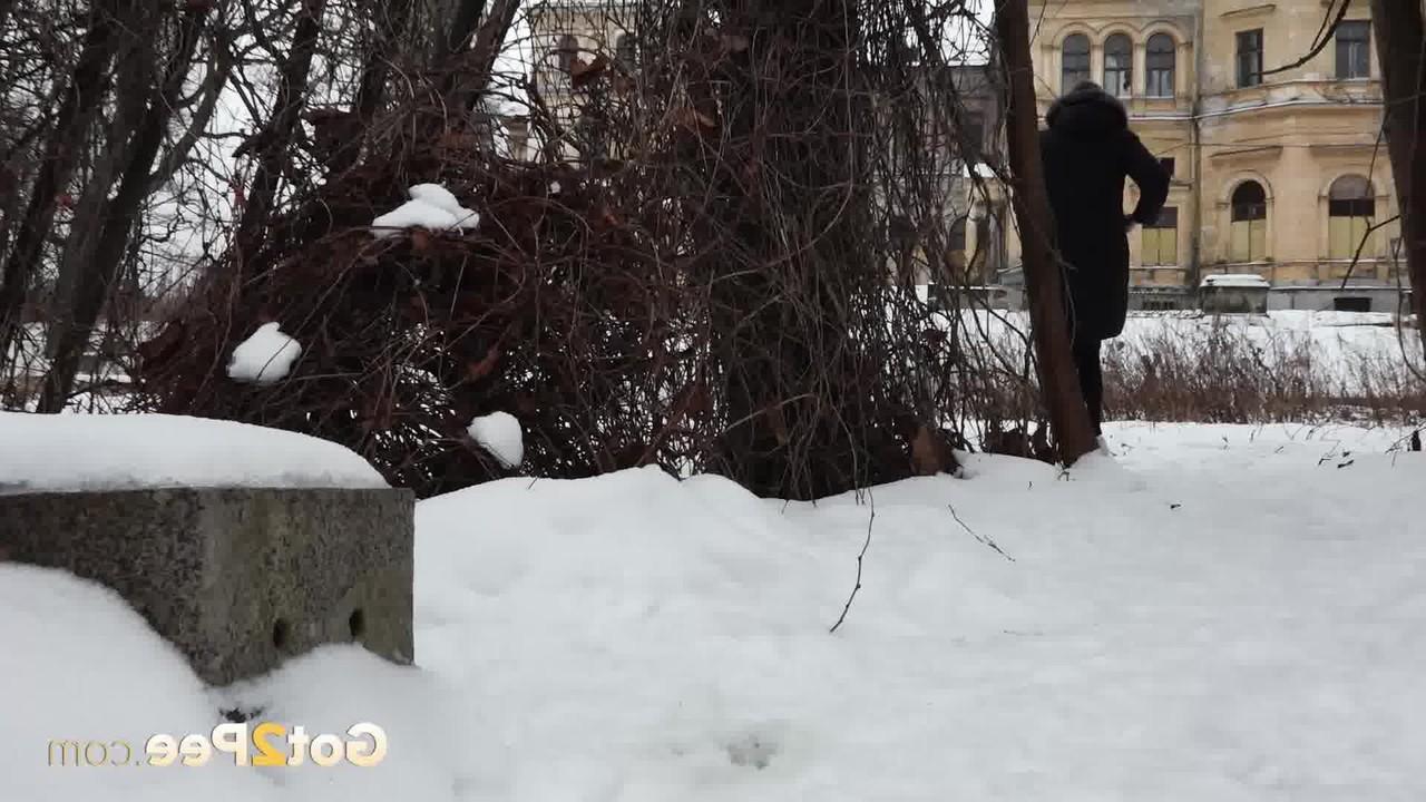 15P Short taken girl Vika squats for a piss on snow-covered ground in the city