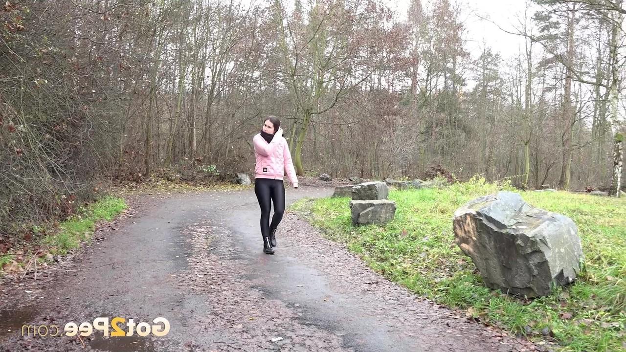 15P Caucasian girl Lara Fox pulls down her pants to pee on a wet path