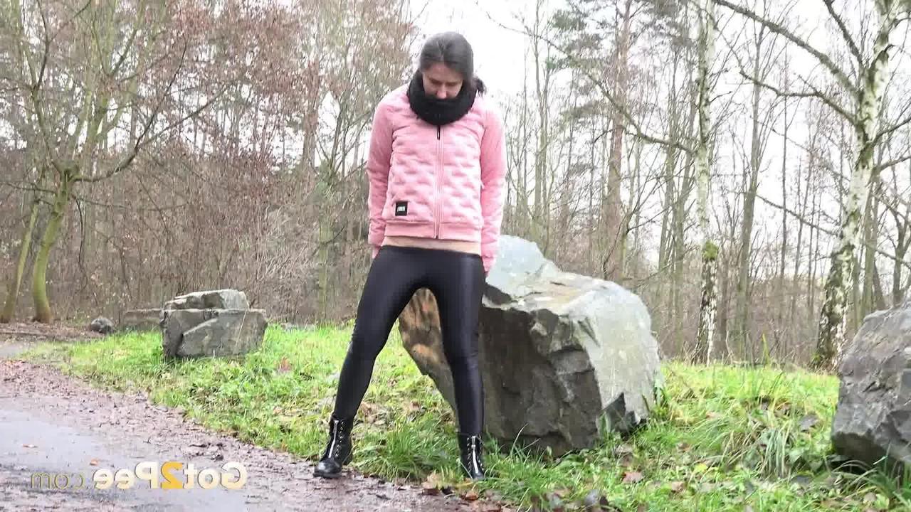 15P Caucasian girl Lara Fox pulls down her pants to pee on a wet path
