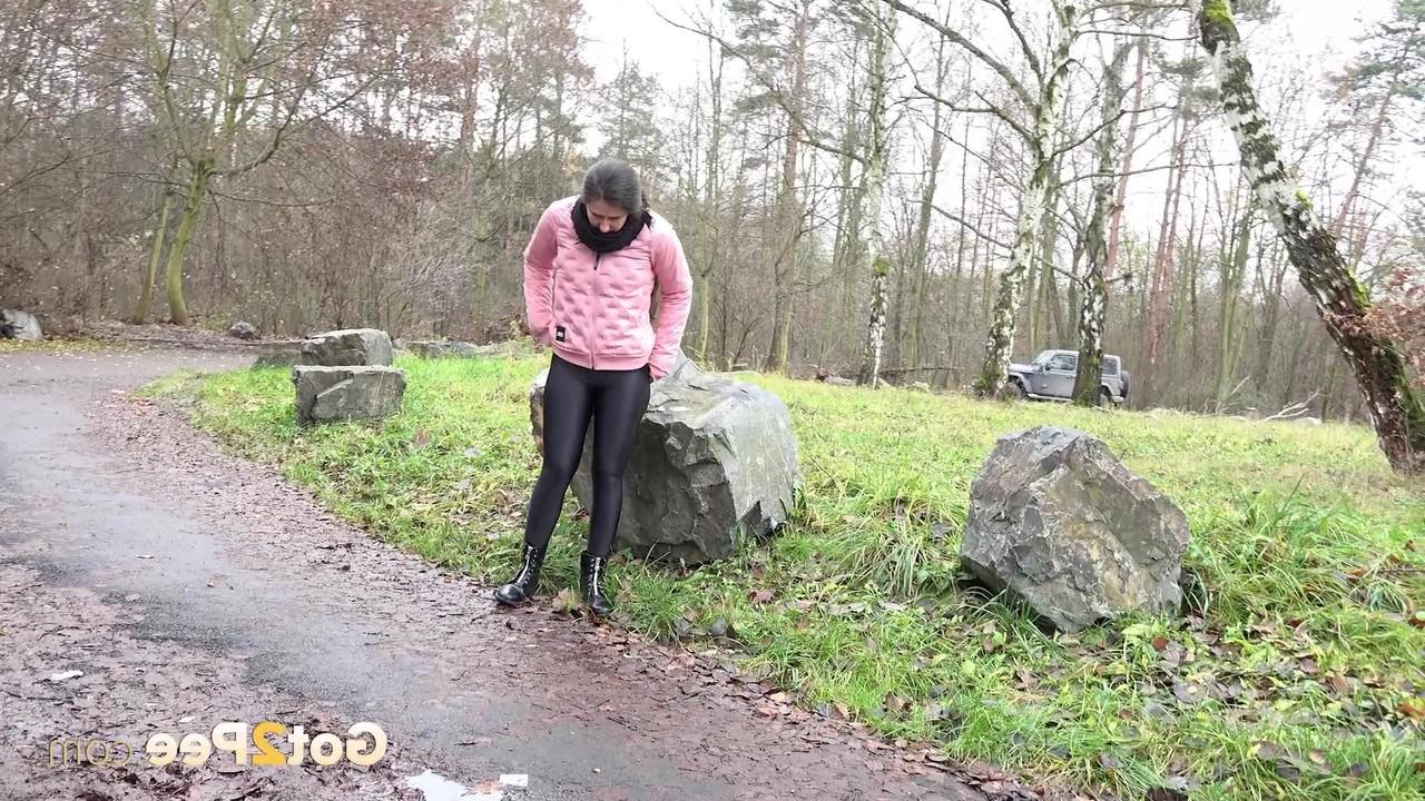 15P Caucasian girl Lara Fox pulls down her pants to pee on a wet path