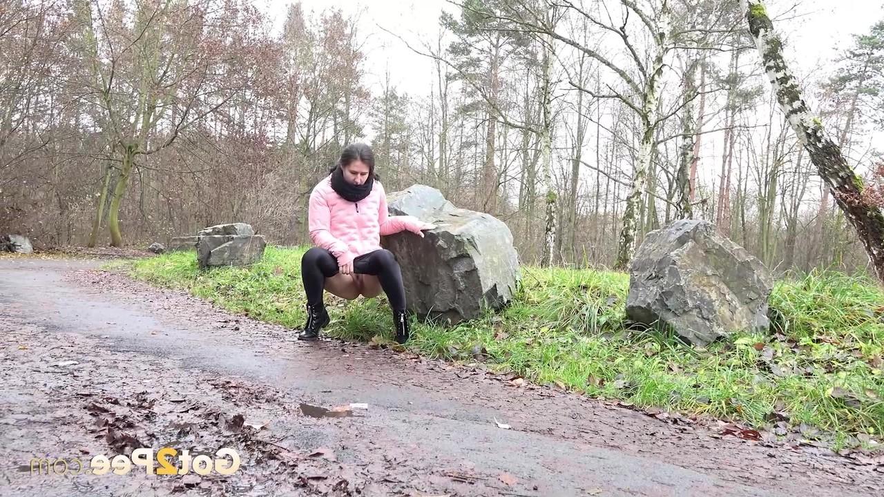 15P Caucasian girl Lara Fox pulls down her pants to pee on a wet path