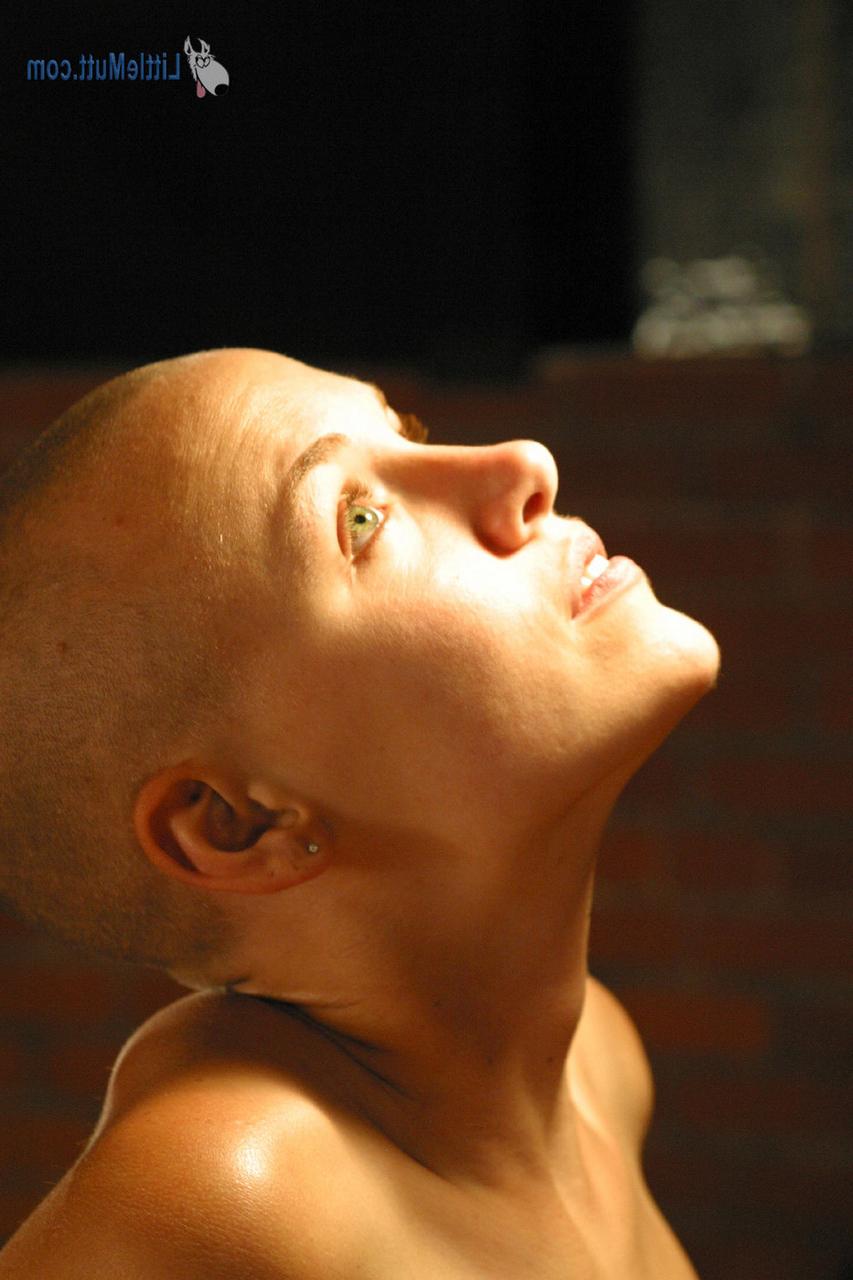 16P Young girl with a shaved head Karissa touches her shaved pussy in the nude