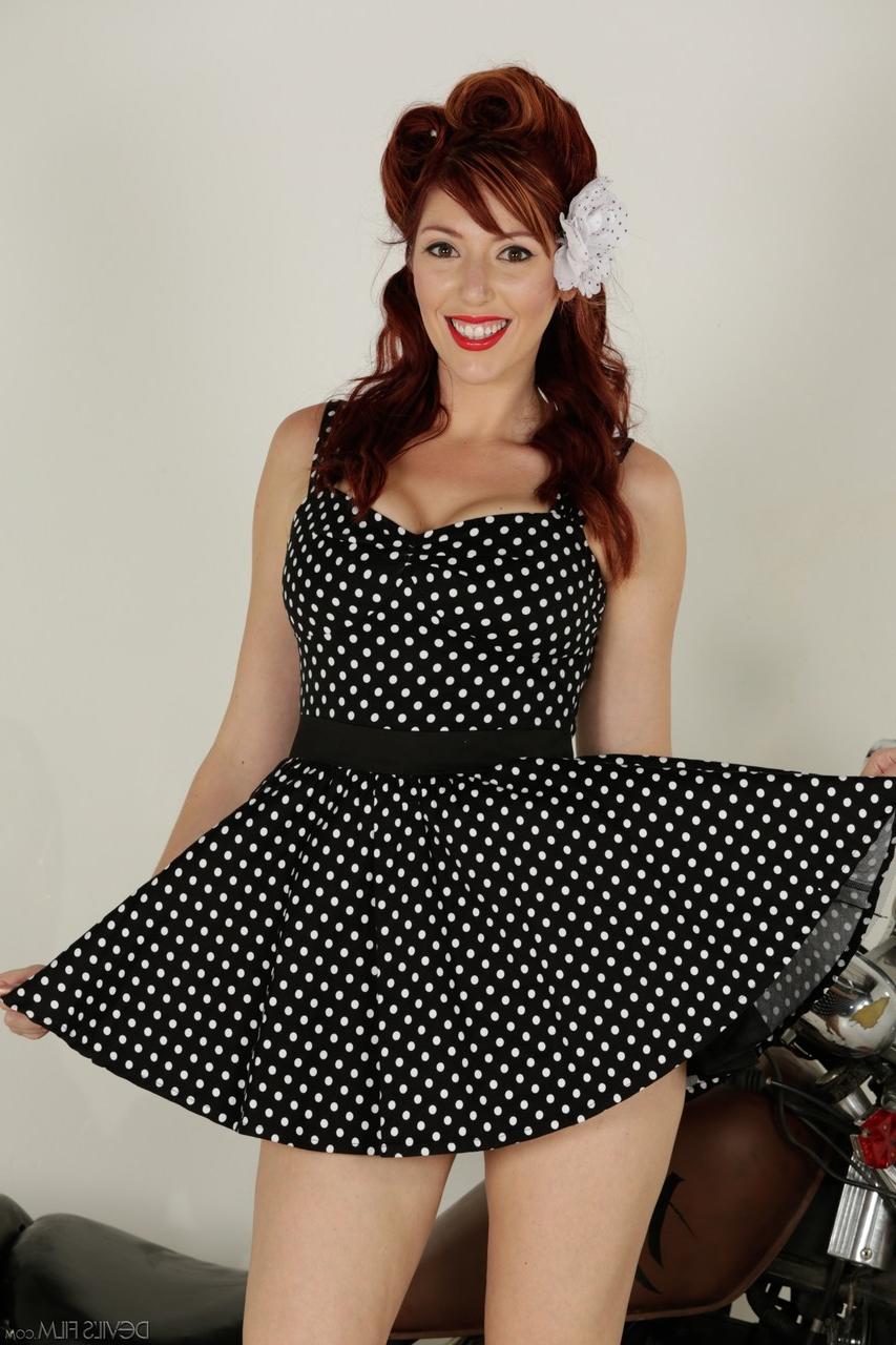 18P Busty pinup redhead Lauren Phillips strips down naked while posing on bike