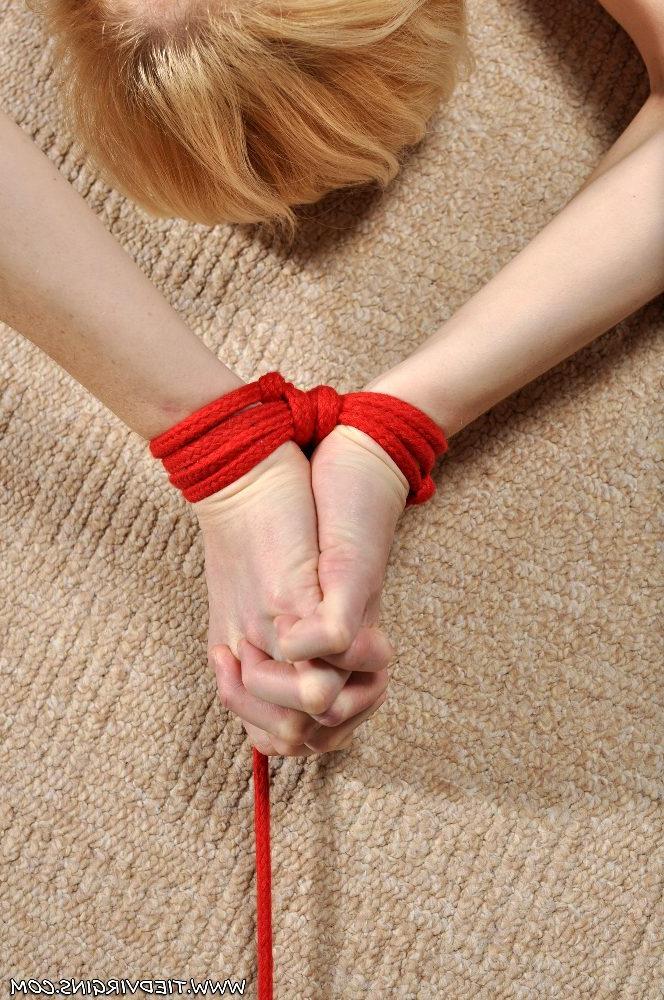 12P Pale redhead has a vibrator affixed to her bald cunt while in bondage