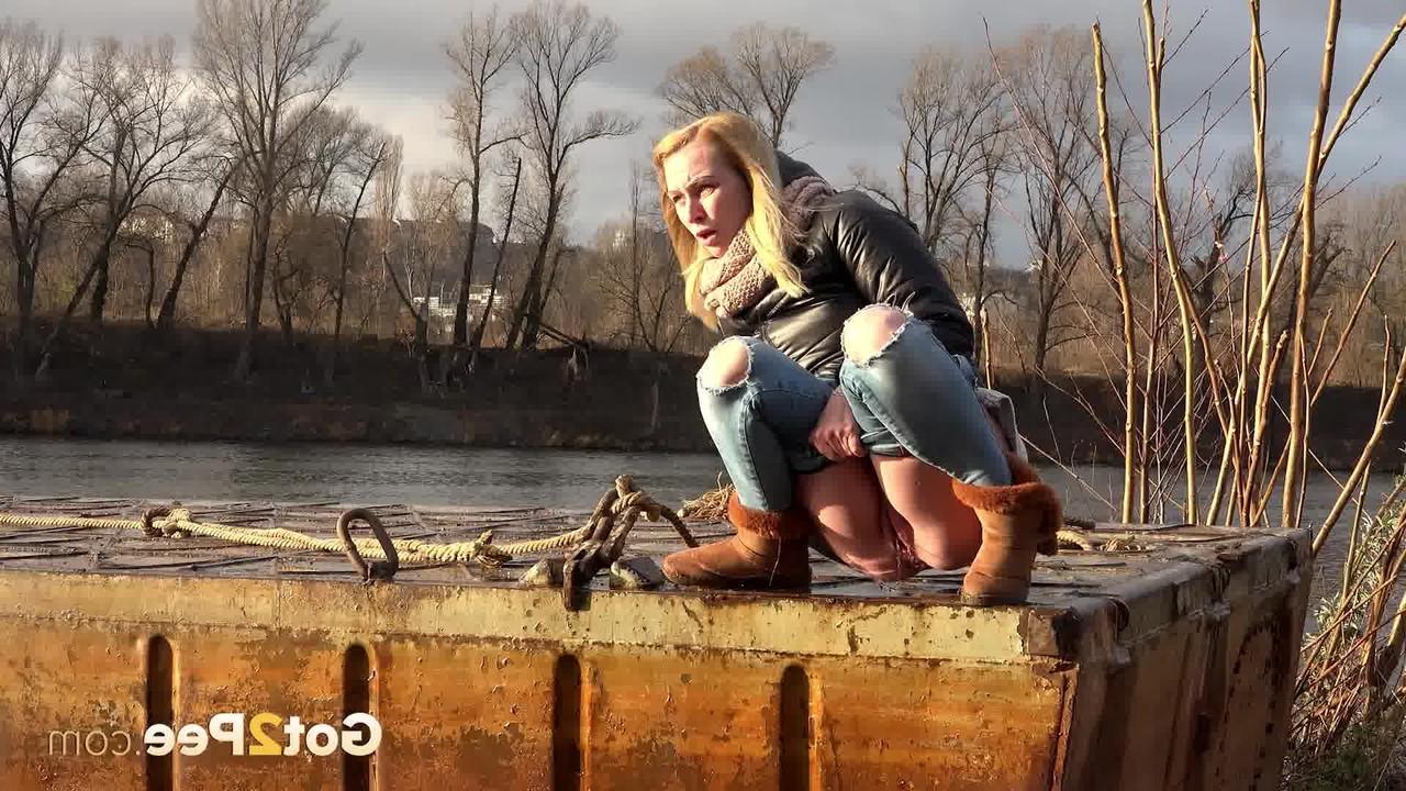 15P Blonde girl Debora squats to take a piss down by a river