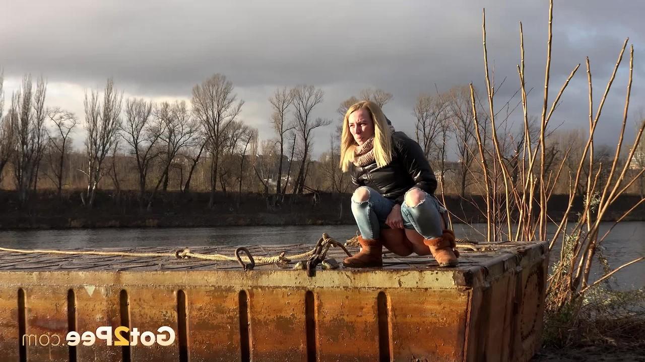 15P Blonde girl Debora squats to take a piss down by a river