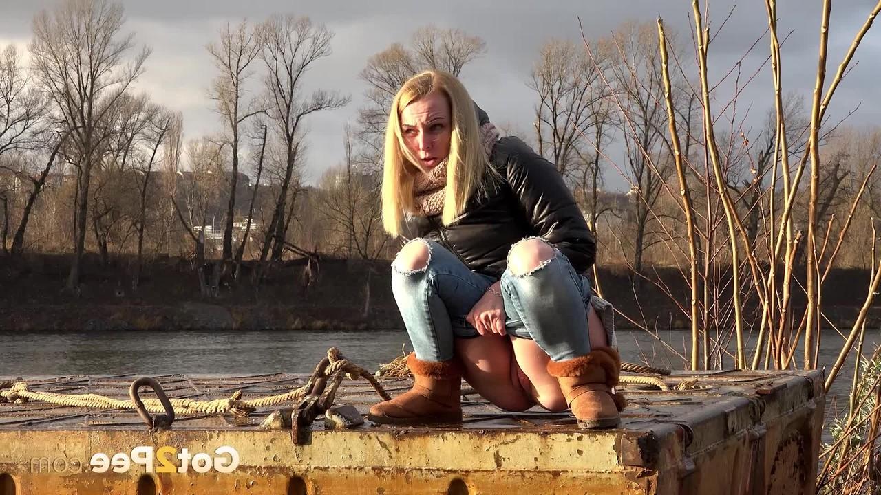 15P Blonde girl Debora squats to take a piss down by a river
