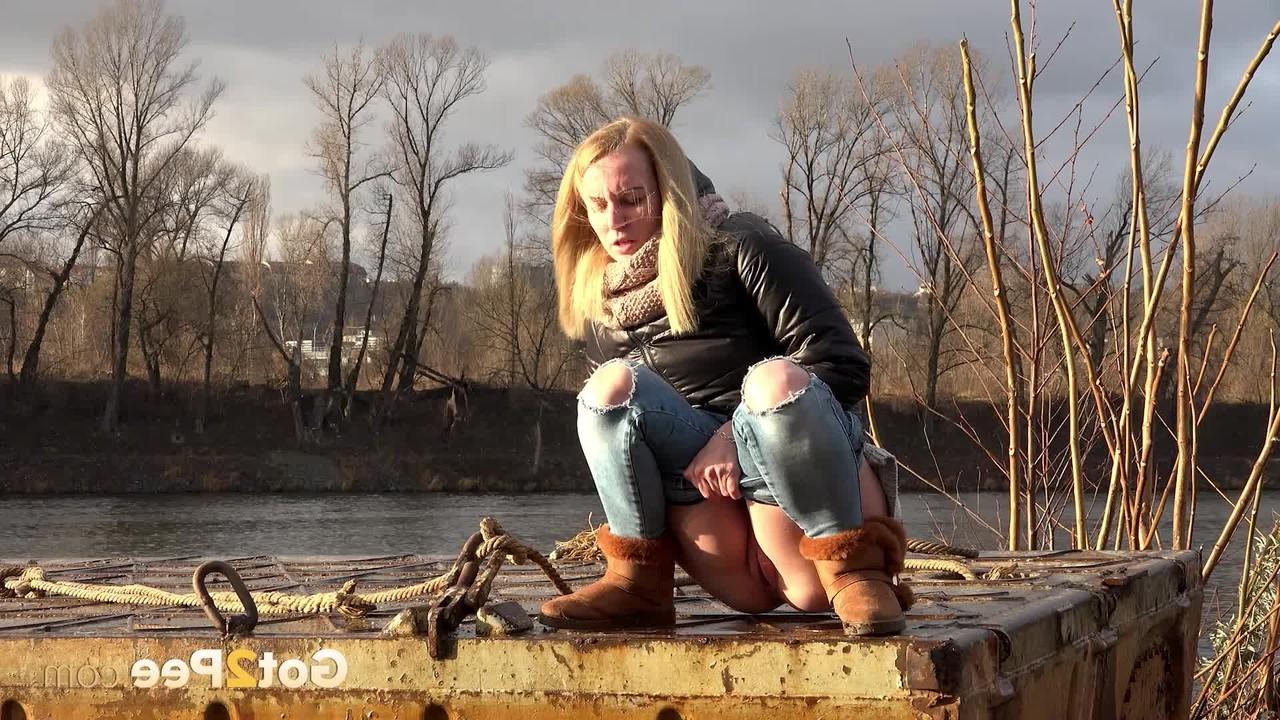 15P Blonde girl Debora squats to take a piss down by a river