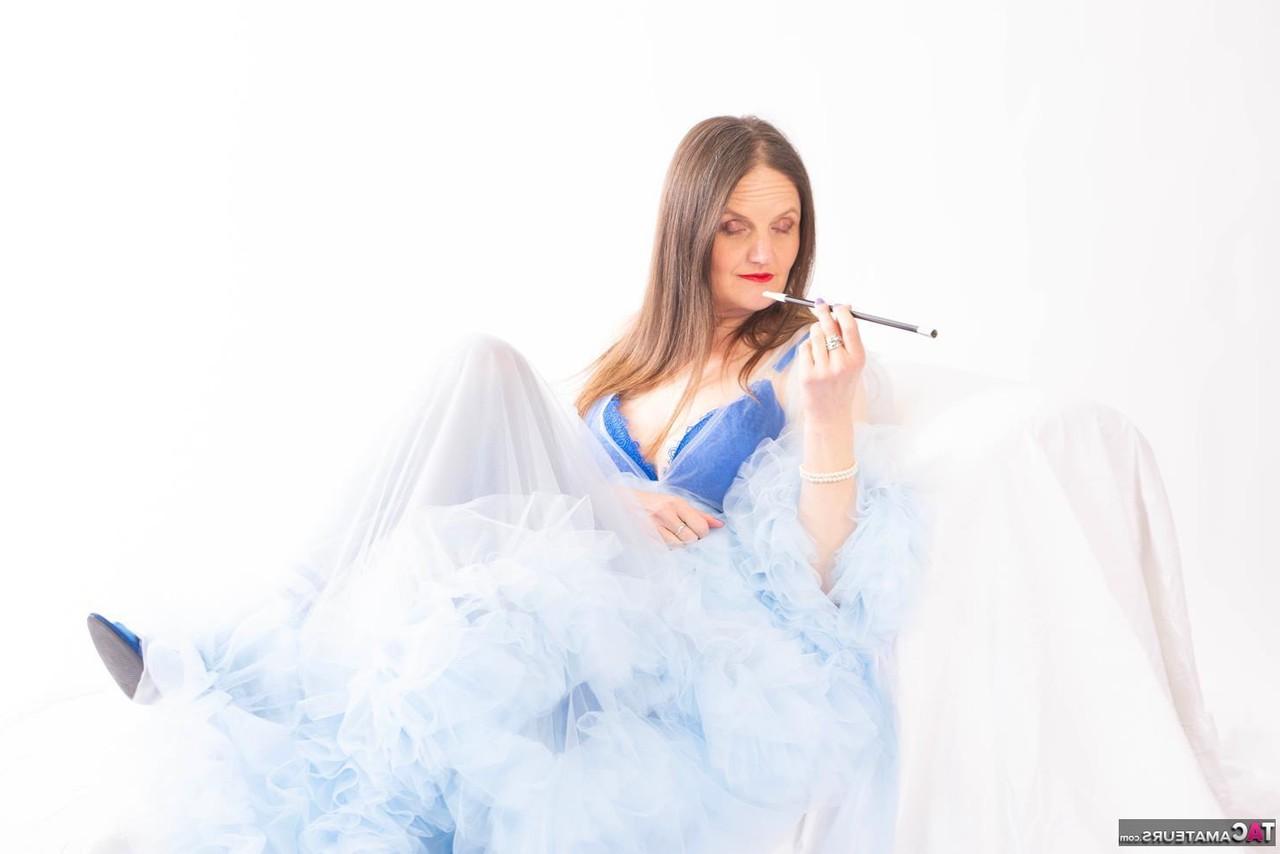 16P Aged lady Reckless Temptation holds a cigarette holder while attracting a man