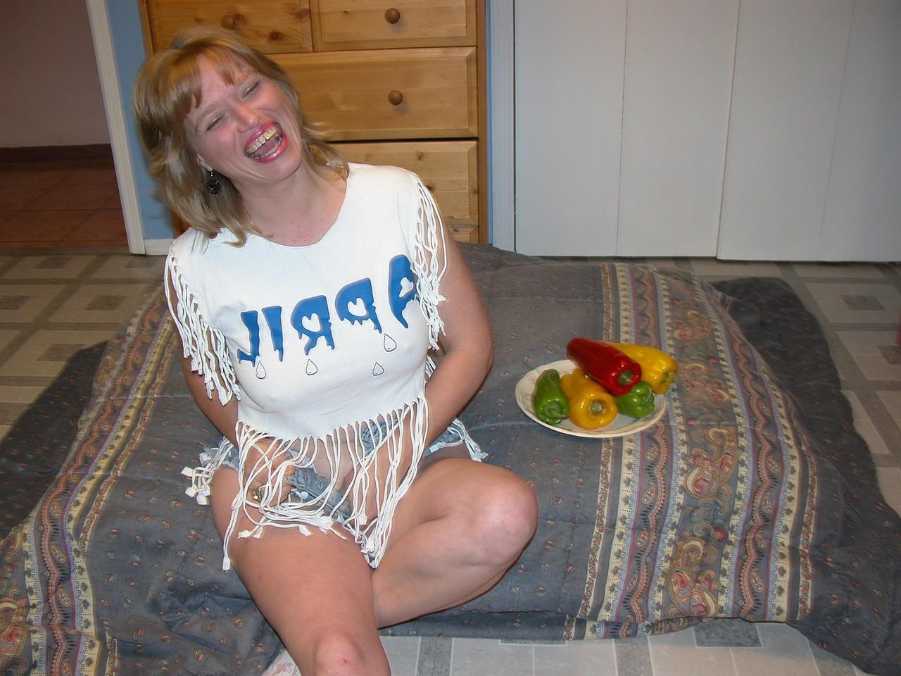20P Naughty MILF April Showers pleasures her shaved pussy with veggies