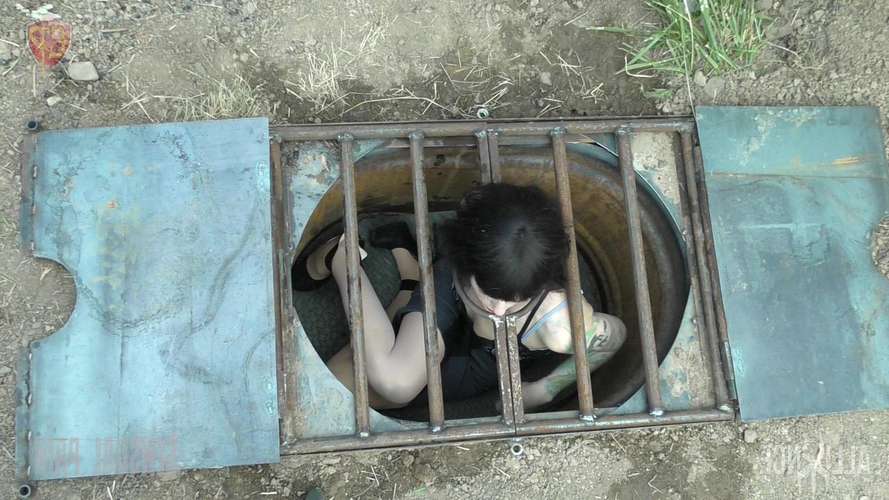 14P Female submissive Abigail Dupree is locked in a hole before being caned