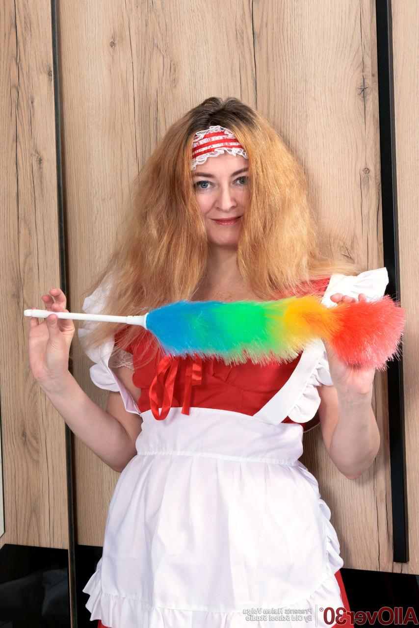 15P Over 30 lady Helen Volga holds a feather duster while getting naked in hosiery