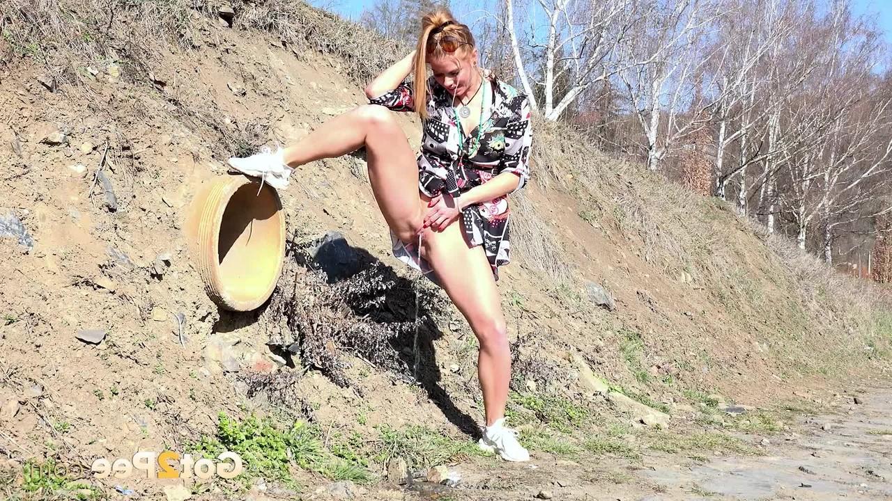 15P Chrissy Fox takes a piss during a walk in the countryside