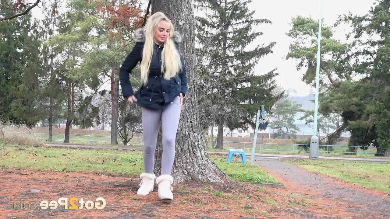 15P Blonde girl Victoria Pure pulls down her leggings to pee against a public tree