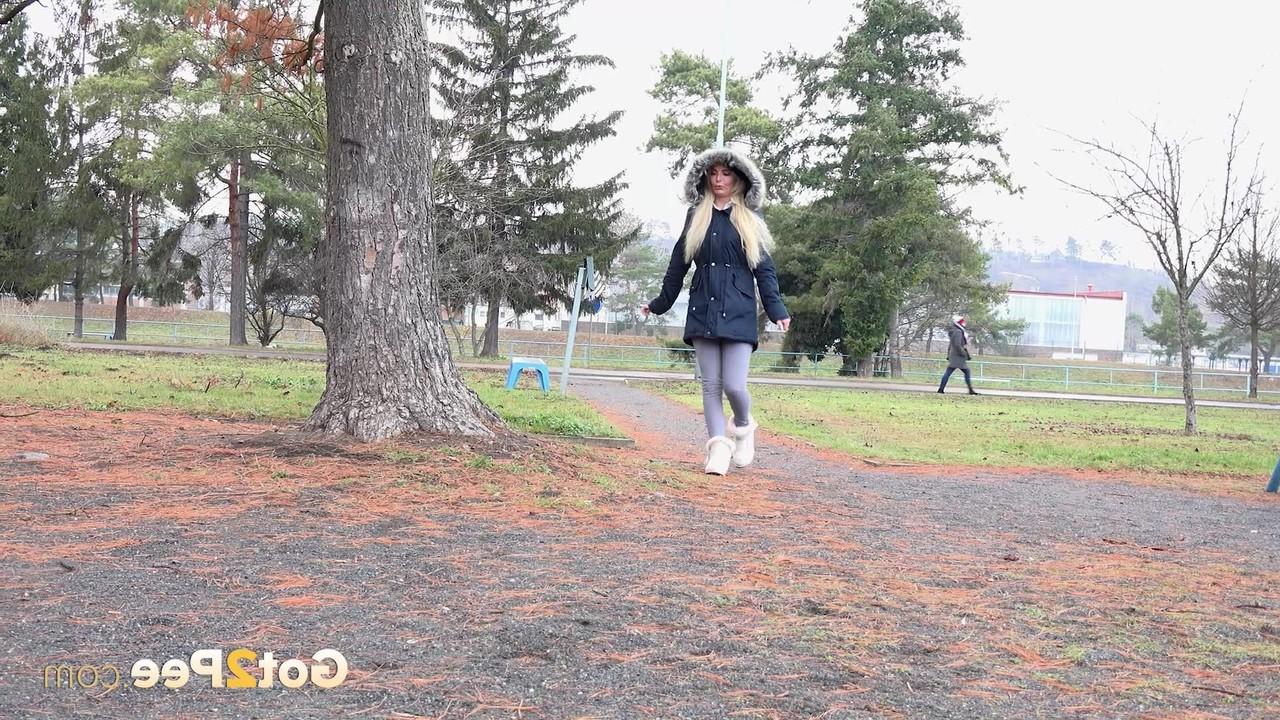 15P Blonde girl Victoria Pure pulls down her leggings to pee against a public tree