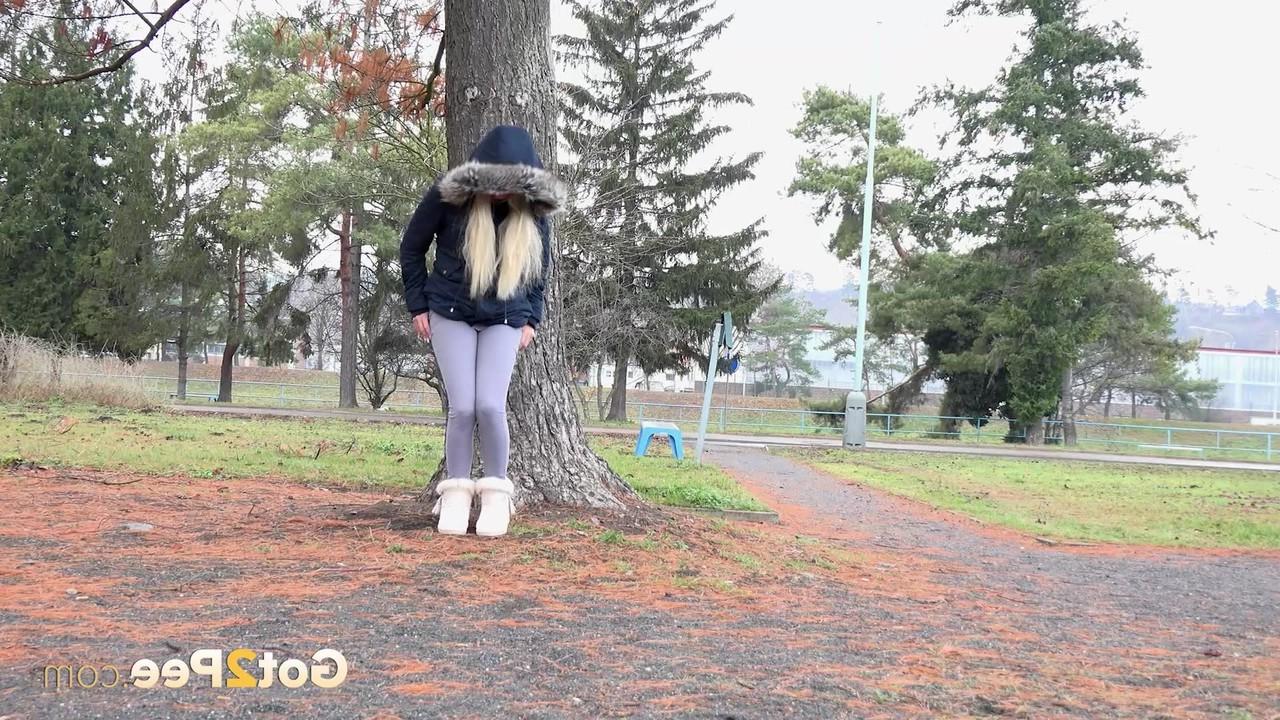 15P Blonde girl Victoria Pure pulls down her leggings to pee against a public tree