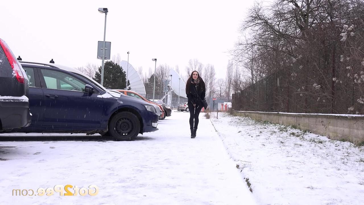 15P Caucasian girl Cynthia Vellons pees on a snow-covered sidewalk during the day