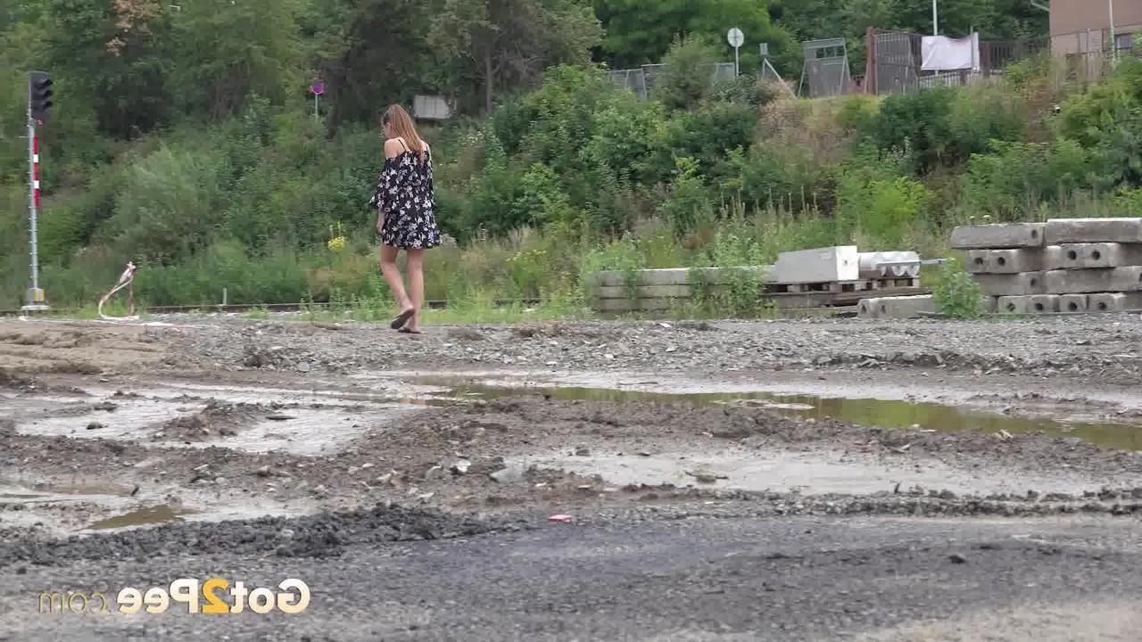 15P Yenna takes a piss in a puddle while wearing flip-flops
