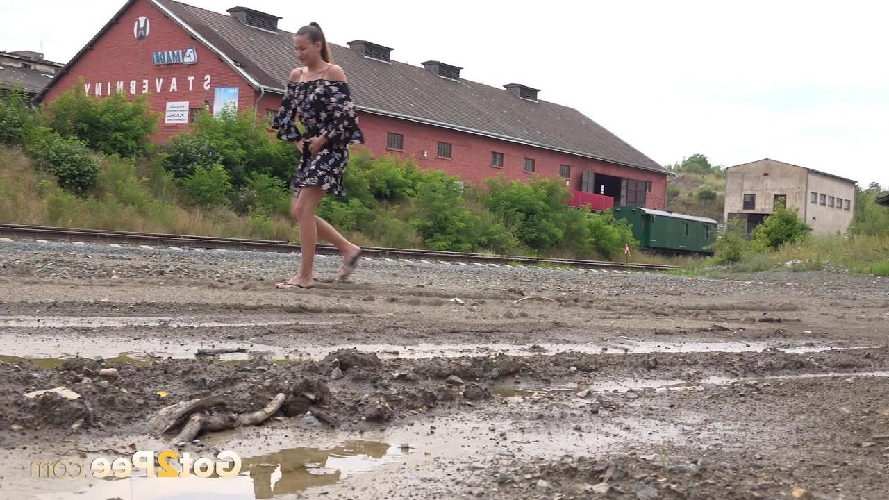 15P Yenna takes a piss in a puddle while wearing flip-flops